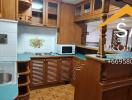 Well-equipped kitchen with wooden cabinetry and green countertops