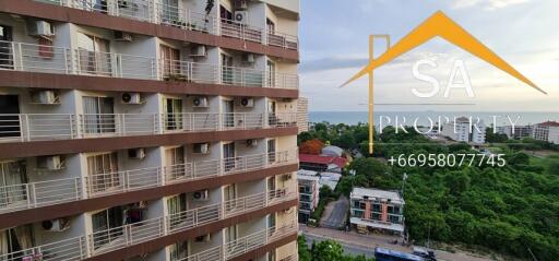 View of apartment building exterior with balconies and air conditioning units