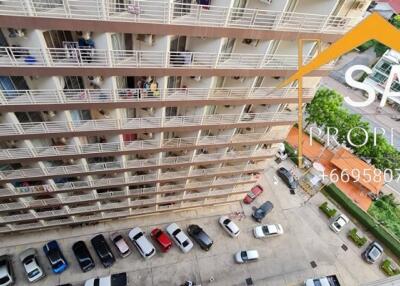 High-angle view of an apartment building with parked cars