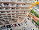 High-angle view of an apartment building with parked cars