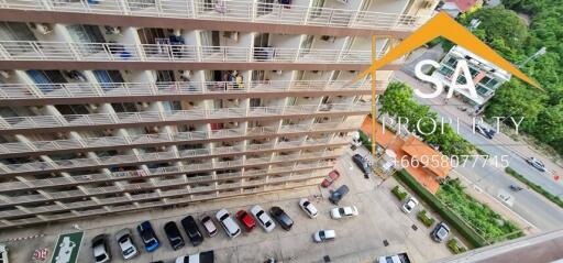 High-angle view of an apartment building with parked cars