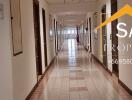 Long hallway in a residential building with multiple doors