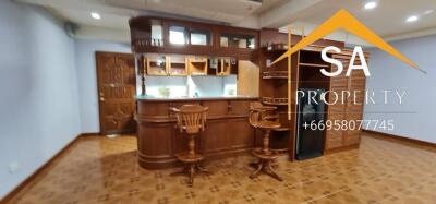 Home bar with wooden furniture and stools in a cozy setting