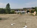 Open land space with some structures in the background