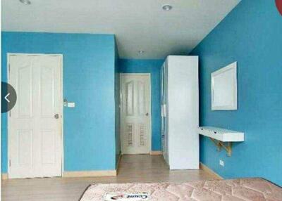 Bedroom with blue walls and white furniture