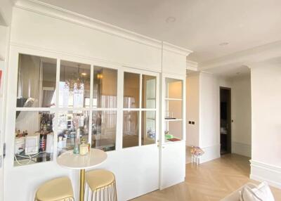 Bright living room with glass-paneled partition and minimalist décor