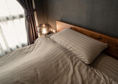 Cozy bedroom with wooden headboard and light-colored bedding