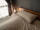 Cozy bedroom with wooden headboard and light-colored bedding