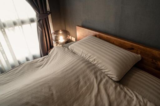 Cozy bedroom with wooden headboard and light-colored bedding