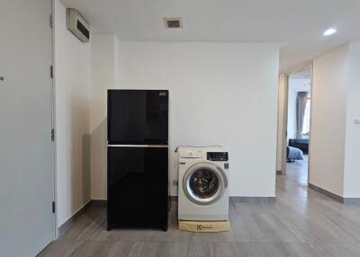 Laundry area with refrigerator and washing machine