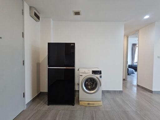 Laundry area with refrigerator and washing machine