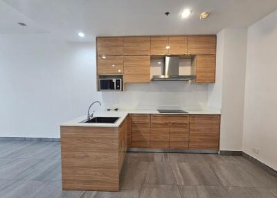 Modern minimalist kitchen with wooden cabinetry and built-in appliances