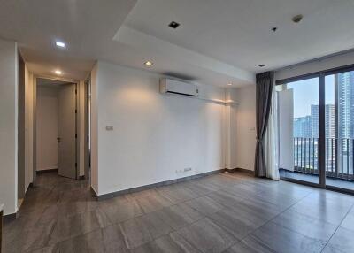 Empty living room with large windows and air conditioning unit