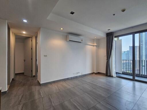 Empty living room with large windows and air conditioning unit