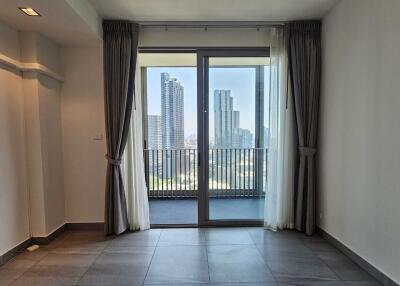 Spacious living area with large window and balcony access