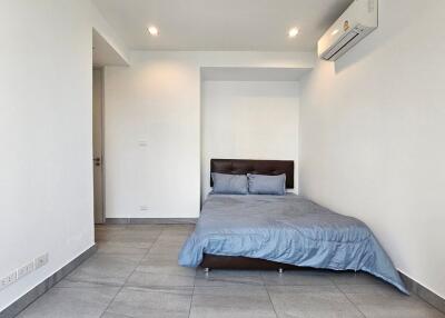 Spacious minimalist bedroom with air conditioning