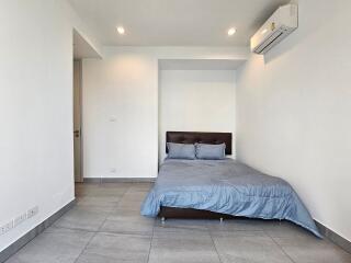 Spacious minimalist bedroom with air conditioning