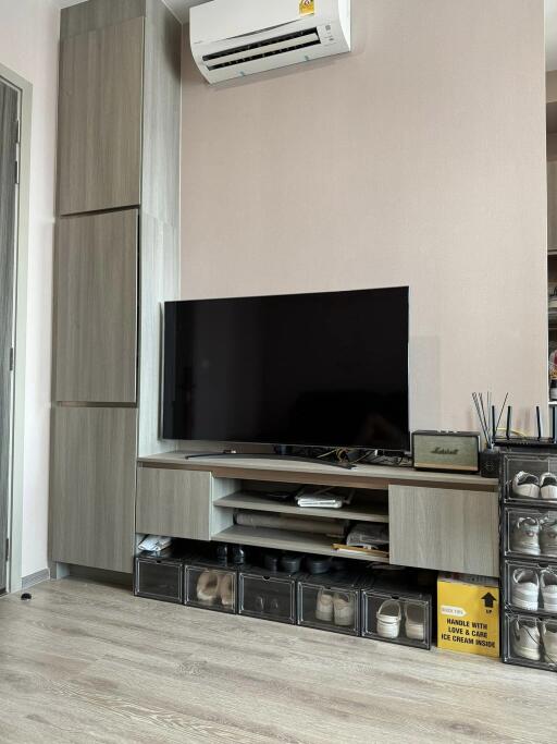 Living room with entertainment center and air conditioning