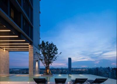 Modern rooftop pool area with city view at twilight