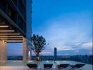 Modern rooftop pool area with city view at twilight