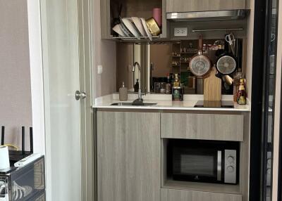 Modern small kitchen with wooden cabinets and stainless steel appliances