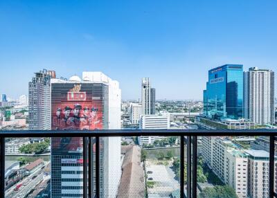 View from the balcony overlooking city buildings with clear blue sky