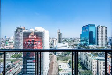 View from the balcony overlooking city buildings with clear blue sky