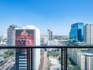 View from the balcony overlooking city buildings with clear blue sky