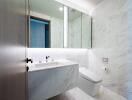 Modern bathroom with marble walls and mirrored cabinets