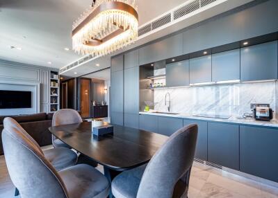 Modern kitchen with dining table and chandelier