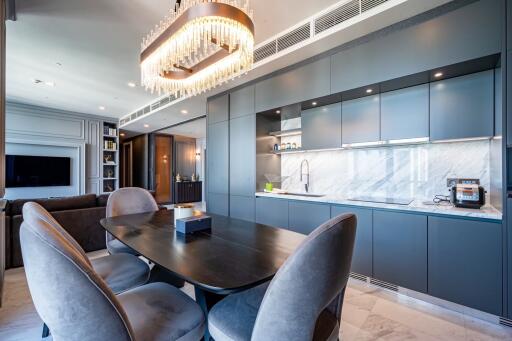 Modern kitchen with dining table and chandelier