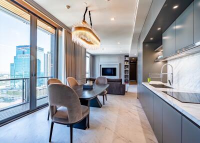 Modern kitchen and dining area in an open-concept living space with city view