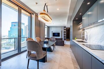 Modern kitchen and dining area in an open-concept living space with city view