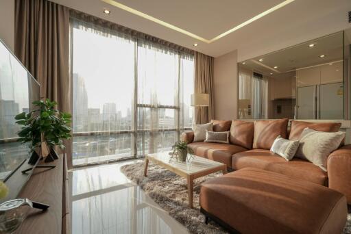 Spacious modern living room with large windows and city view