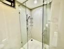 Glass-walled modern shower area with fixtures