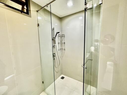 Glass-walled modern shower area with fixtures