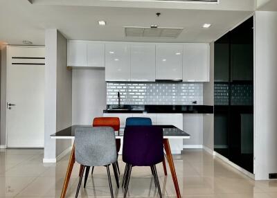 Modern kitchen with dining table and colorful chairs