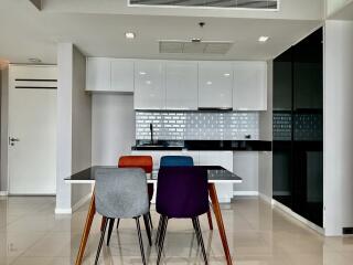 Modern kitchen with dining table and colorful chairs