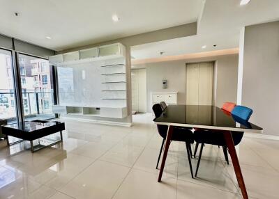 Modern living room with glass dining table and built-in TV unit