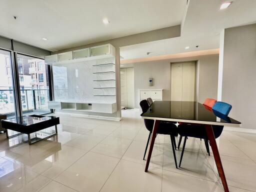 Modern living room with glass dining table and built-in TV unit