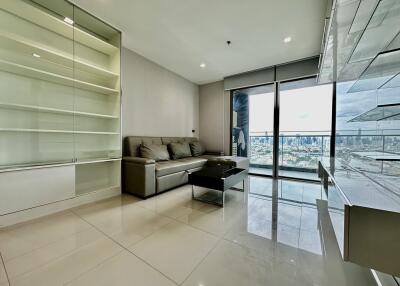 Modern living room with glass doors overlooking cityscape