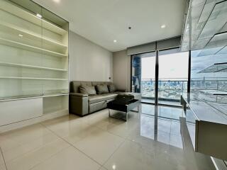 Modern living room with glass doors overlooking cityscape