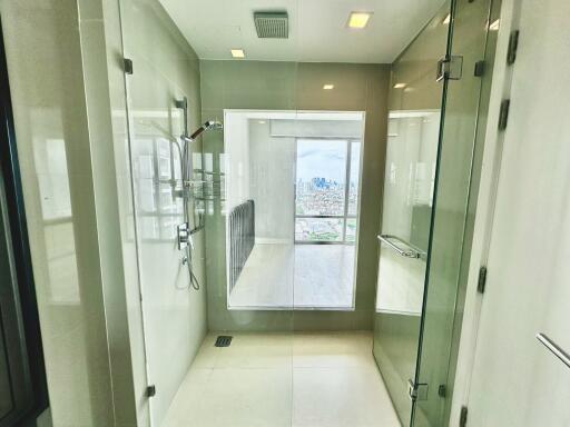 Modern bathroom with glass-enclosed shower and city view