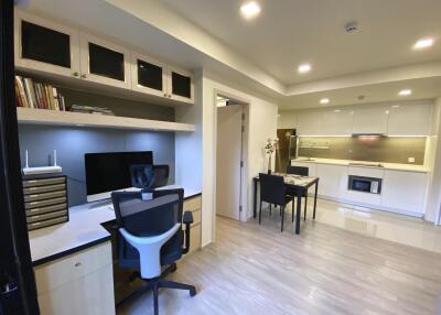 Modern studio apartment with office area and kitchen