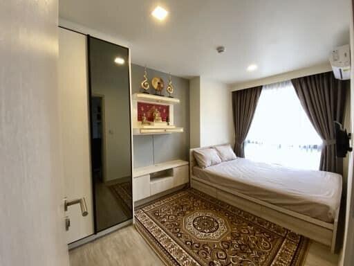 Modern bedroom with bed, wardrobe, and decorative elements