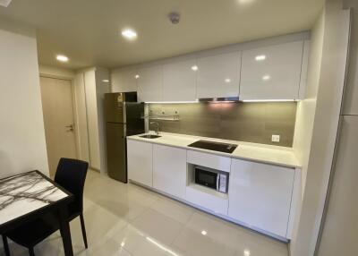 Modern kitchen with sleek white cabinets and appliances