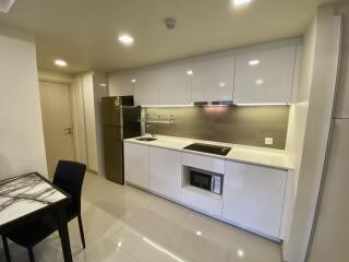 Modern kitchen with sleek white cabinets and appliances