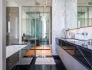 Modern bathroom with glass shower, bathtub, and dual sink vanity