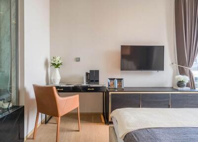 Modern bedroom with a desk, wall-mounted TV, and large window