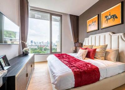 Modern bedroom with city view, large window, and elegant decor